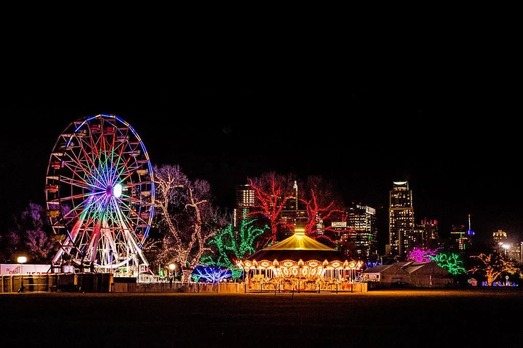 The Zilker Trail of Lights at night with the Ferris wheel and skyline