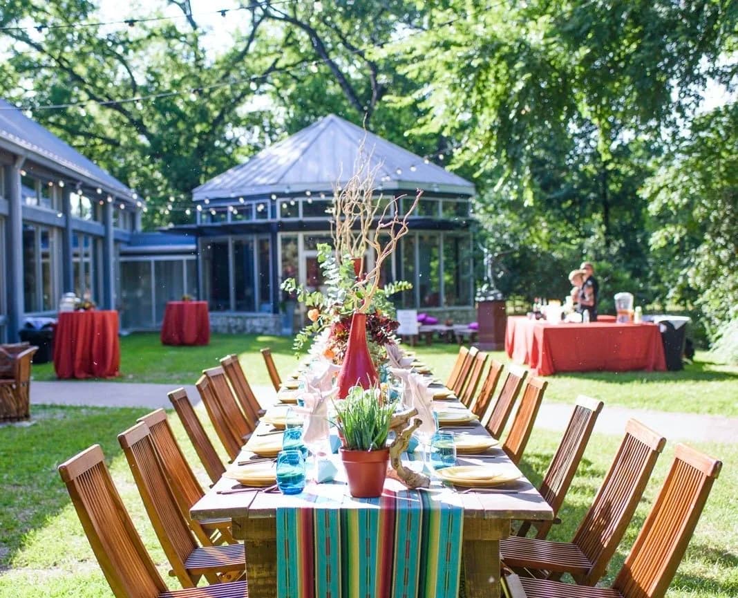 A banquet table set for an outdoor event on the grounds of a Zilker Park venue