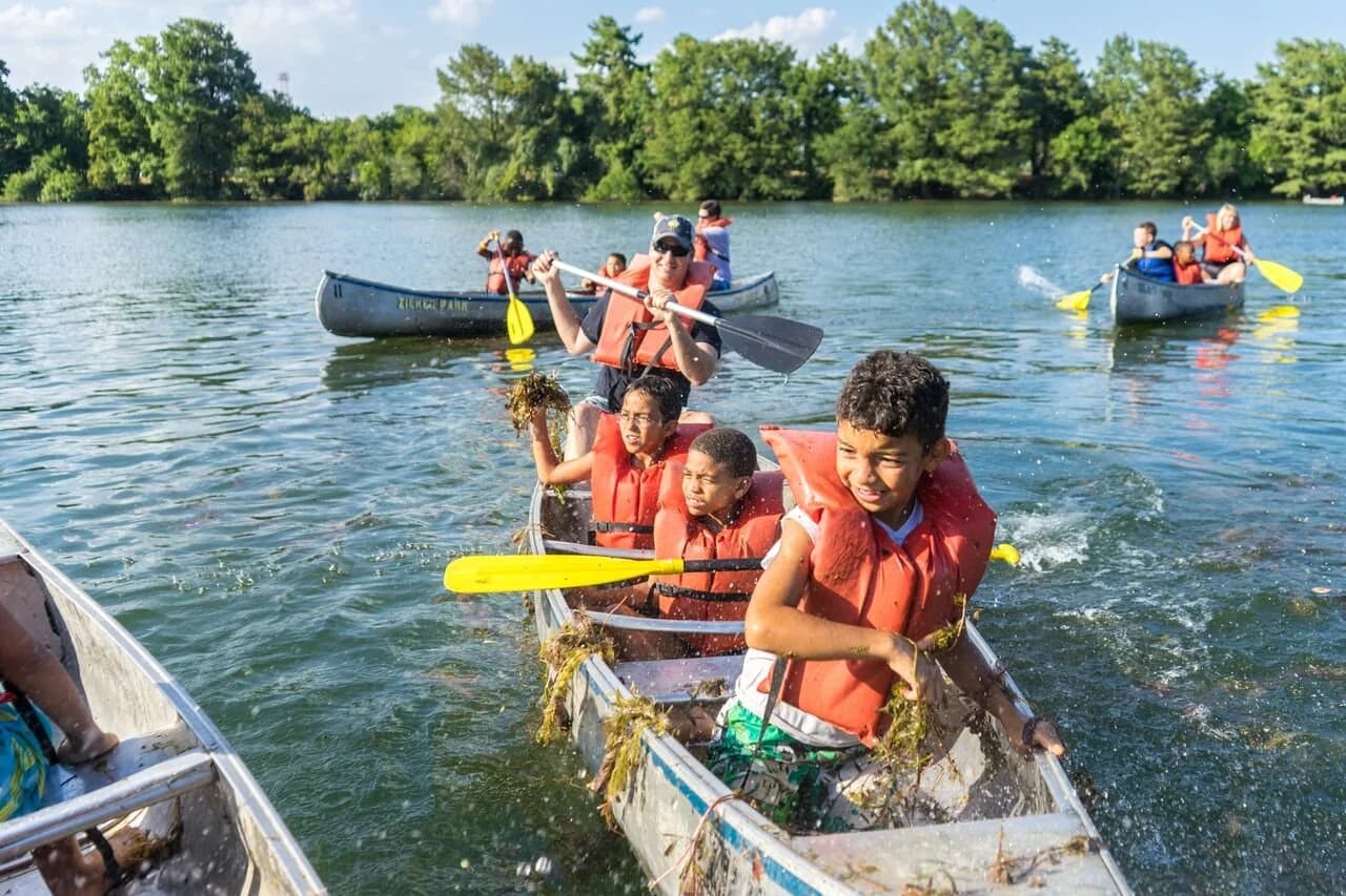 Young people canoeing together on Lady Bird Lake beside Zilker Park